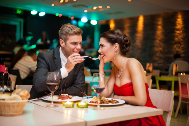 Lovely young couple eating on romantic dinner